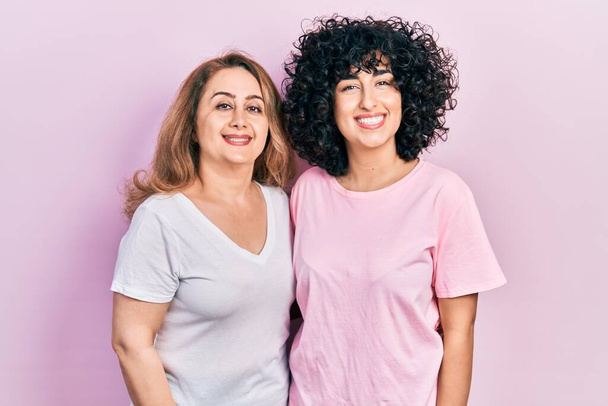Middle east mother and daughter wearing casual clothes with a happy and cool smile on face. lucky person.  - Photo, Image