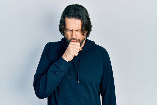 Middle age caucasian man wearing casual sweatshirt feeling unwell and coughing as symptom for cold or bronchitis. health care concept.  - Photo, Image