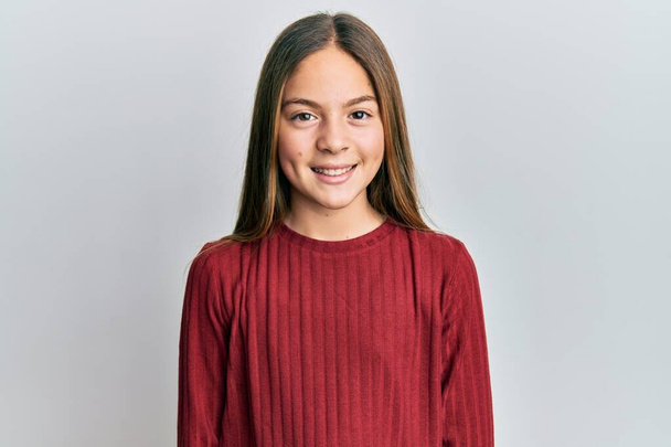 Beautiful brunette little girl wearing casual sweater with a happy and cool smile on face. lucky person.  - Zdjęcie, obraz