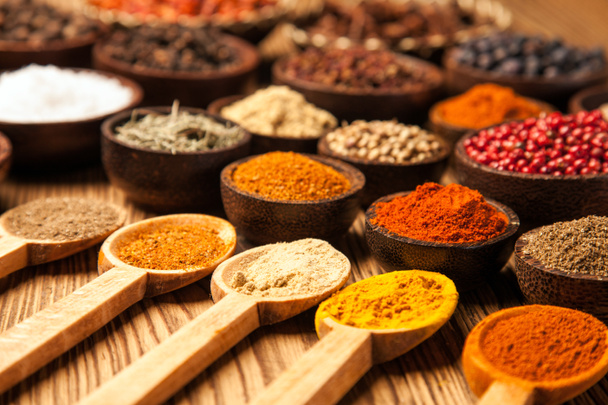 Spices and herbs in wooden bowls. - Photo, Image