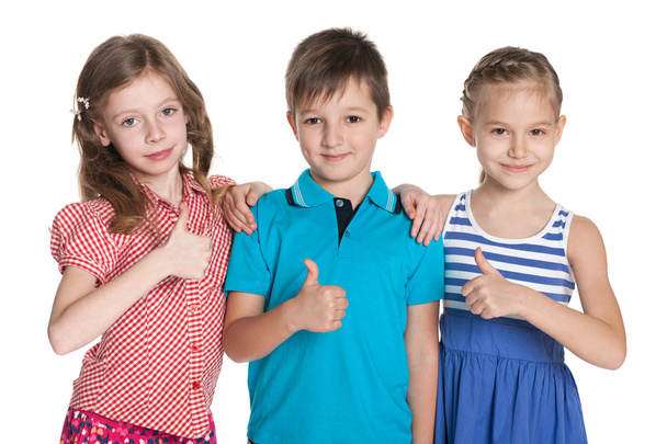 Three cheerful children hold his thumbs up - Foto, Imagen