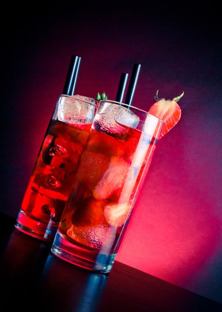 glasses of strawberry cocktail with ice on wood table - Photo, image
