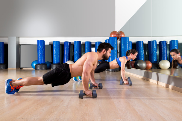Dumbbells push-ups couple at fitness gym  - Valokuva, kuva