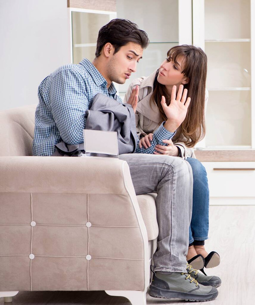 Young couple disappointed with price in furniture store - Foto, afbeelding