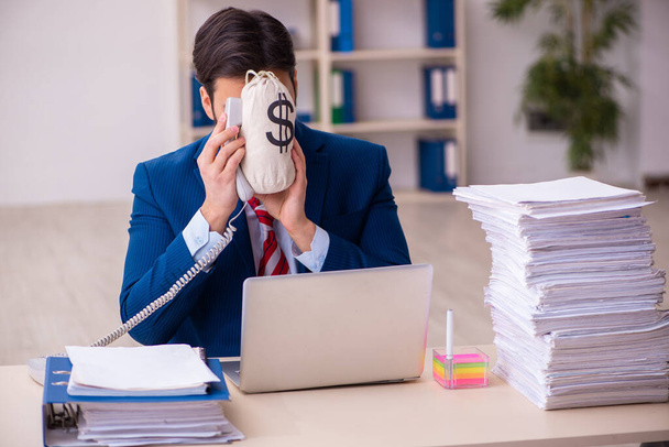 Young businessman employee unhappy with excessive work in the office - Photo, Image