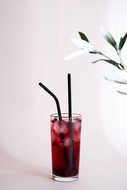 Refreshing berry juice with ice. Minimalistic still life of a summer cocktail. - Photo, Image