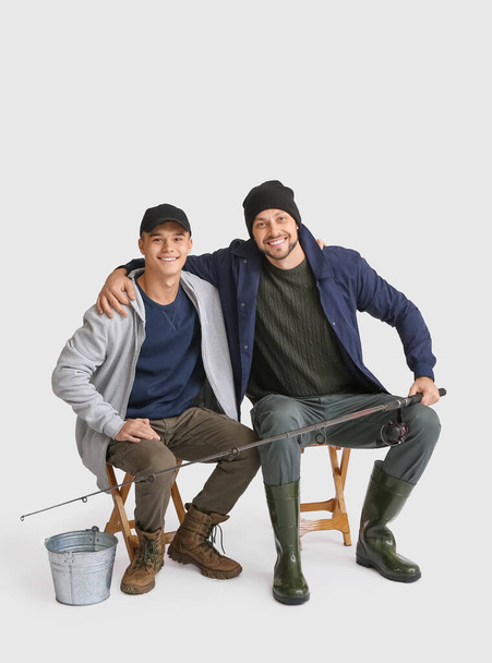Happy father and son fishing on white background - Foto, imagen