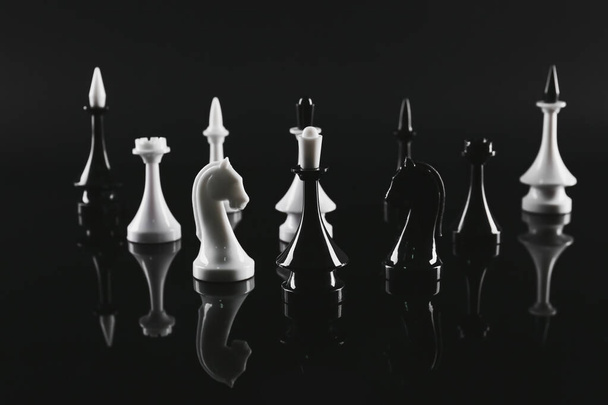Chess pieces on dark background - Фото, изображение