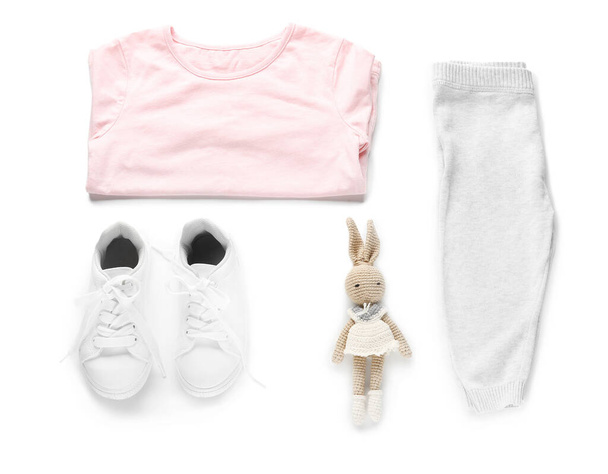 Set of child's clothes and toy on white background - Foto, Imagen