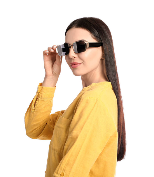 Beautiful young woman wearing stylish sunglasses on white background - Foto, afbeelding