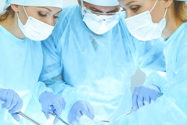 A group of surgeons is operating at the hospital. Health care concept - Φωτογραφία, εικόνα