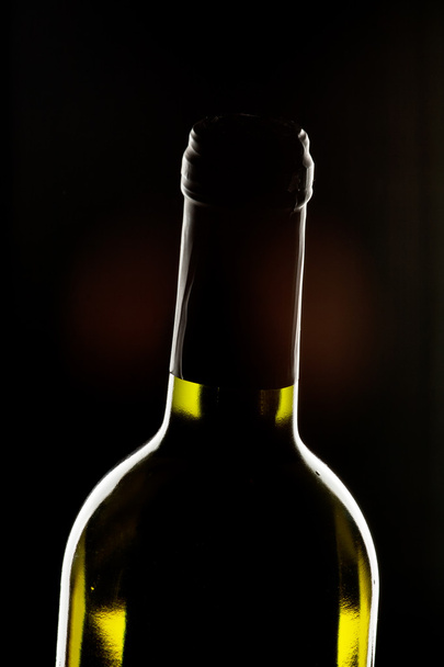 Wine bottle on dark background - Foto, imagen