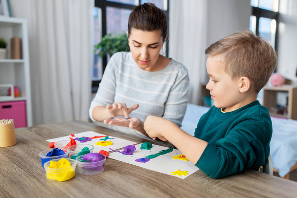mother and son playing with modeling clay at home - Φωτογραφία, εικόνα
