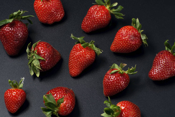 Juicy strawberries on a black background. - Photo, image