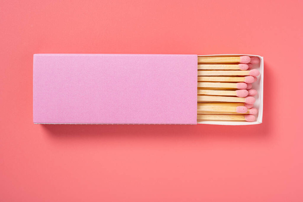 pink color matchbox and pink match sticks on a pink background - Fotó, kép