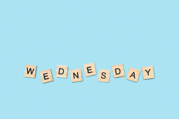 Wednesday write with wooden letter cubes on a light blue background - Zdjęcie, obraz