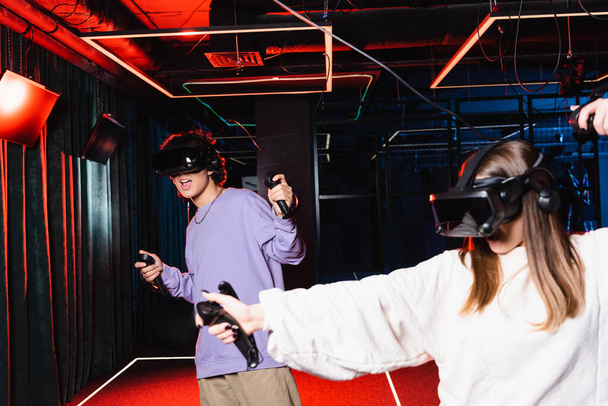 multiethnic teenagers in headsets gaming in vr play room - Foto, imagen