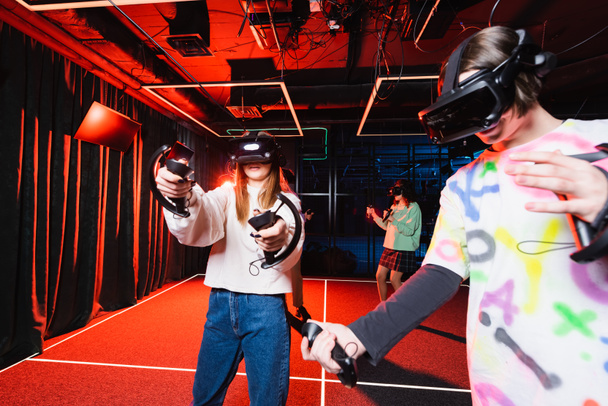multiethnic friends in vr headsets gaming in play zone - Foto, Imagem