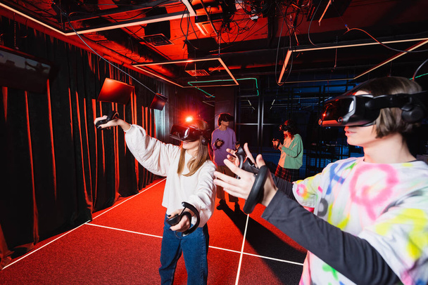 друзья-подростки развлекаются в игровой зоне виртуальной реальности - Фото, изображение