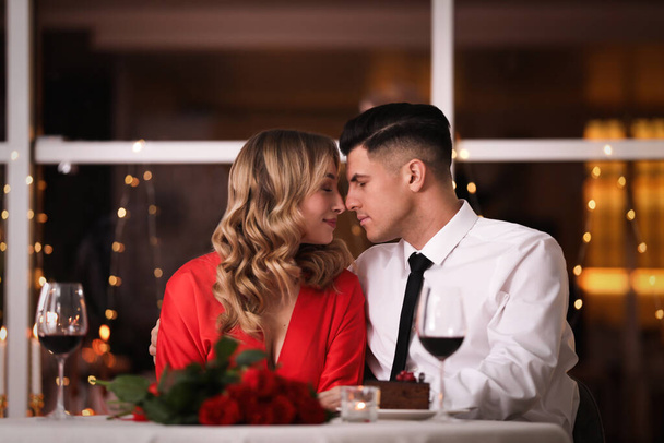 Lovely couple having romantic dinner on Valentine's day in restaurant - Foto, afbeelding
