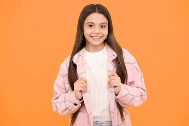 looking cool. smiling hipster kid casual style. tween child wear plaid shirt. flannel jacket. beauty and fashion. latest trend. street autumn fashion. happy teen girl in pink checkered shirt. - Photo, Image