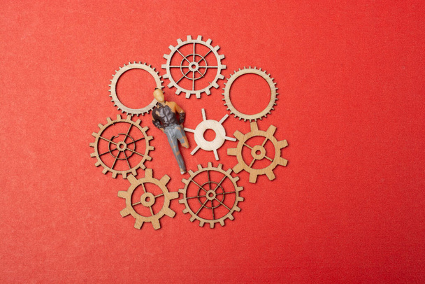 Little tiny man person figurine  and gear wheels as industry concept - Photo, Image