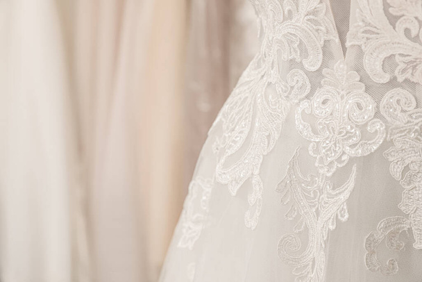Beautiful wedding dress on mannequin in boutique, closeup - Foto, Bild