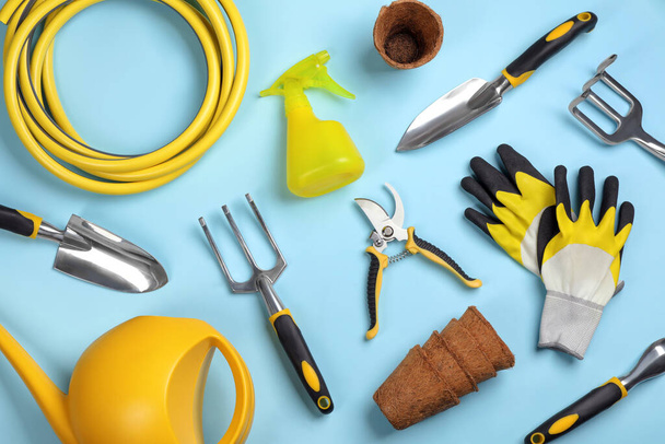 Flat lay composition with gardening tools on light blue background - Photo, Image