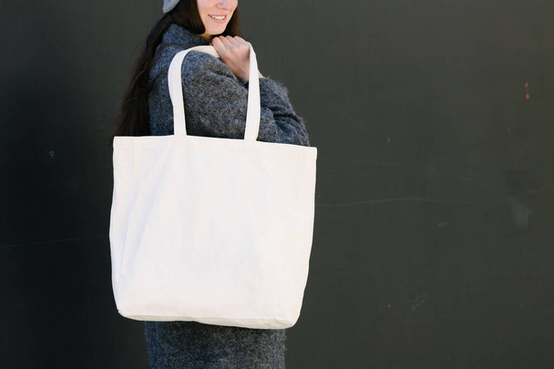 Woman holding tote cotton bag outside - Foto, imagen
