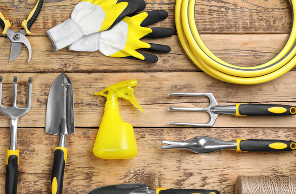 Flat lay composition with gardening tools on wooden background - Photo, Image