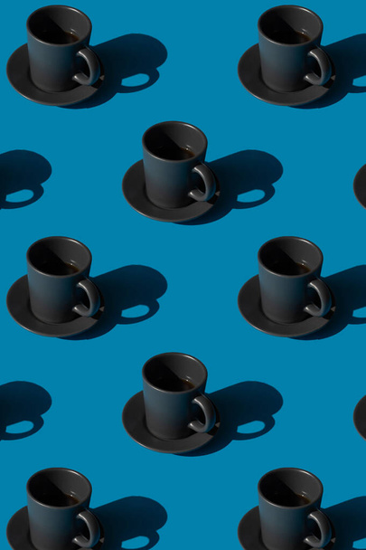 Cup of espresso coffee on a blue background pattern. Minimal concept. - Фото, изображение
