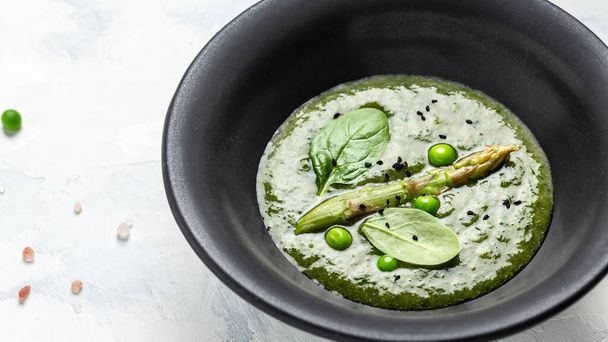 Asparagus cream soup on gray stone background, Vegetarian healthy food. Long banner format, top view. - Foto, Bild