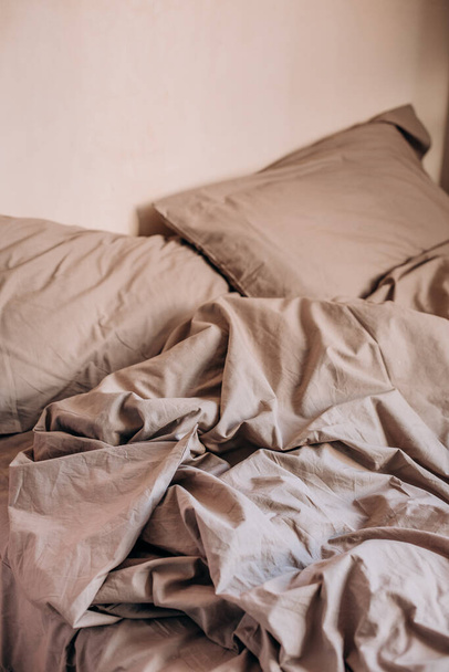 morning bed ruffled after sleep wrinkled textile blanket and pillows beig - Photo, image