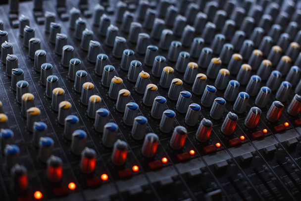 Professionele audio studio geluidsmixer console paneel met opname, faders en instelknoppen, TV-apparatuur. - Foto, afbeelding