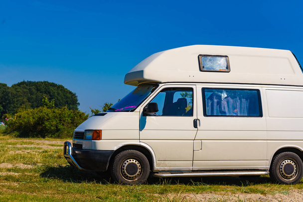 Camper van camping on nature in summer. Traveling by motor home. Caravan vacation. - Zdjęcie, obraz