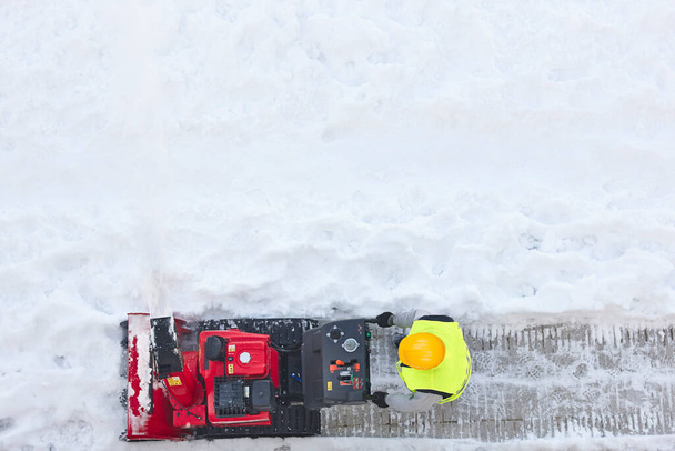 Dělník čistí sníh na chodníku sněhovou frézou. Udržování - Fotografie, Obrázek