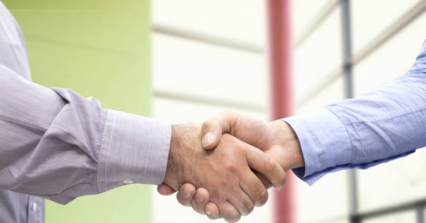 Composition of businessmen shaking hands in office. business, deal, success and finance future concept digitally generated image. - Foto, imagen