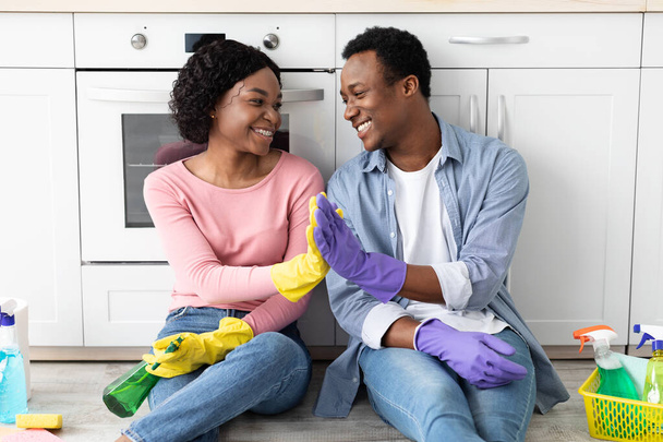 Satisfied black man and woman house-keepers giving high five - Photo, Image