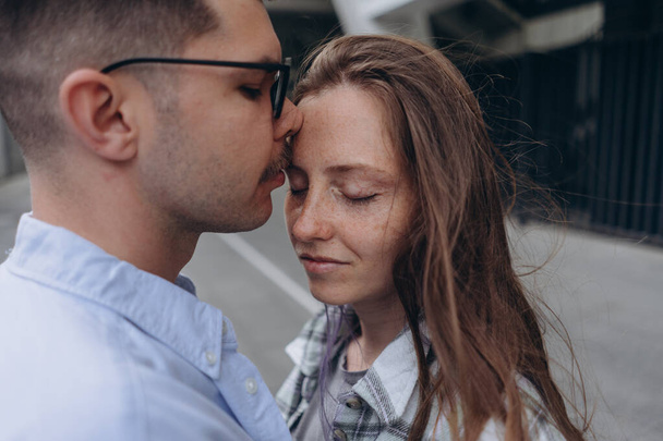 photo of young couple gently embracing each other standing on the street - Foto, immagini