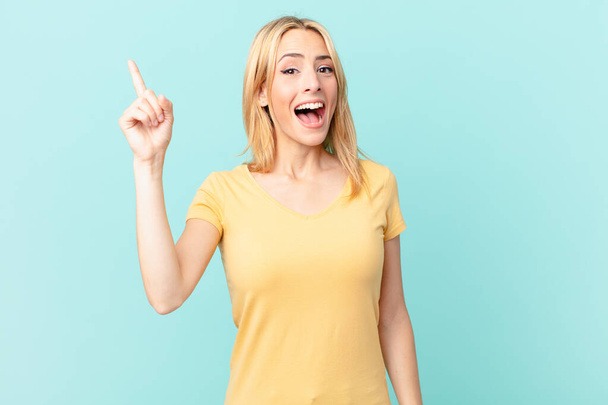 young blonde woman feeling like a happy and excited genius after realizing an idea - Photo, image
