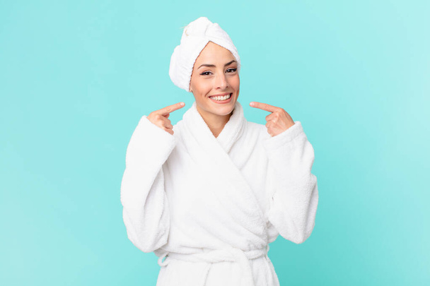 young blonde woman smiling confidently pointing to own broad smile. shower concept. - Photo, image