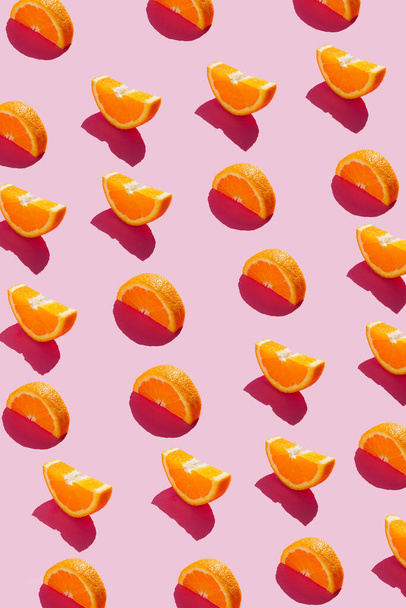 Kreatives Layout aus Orangenscheiben auf pastellrosa Hintergrund. - Foto, Bild
