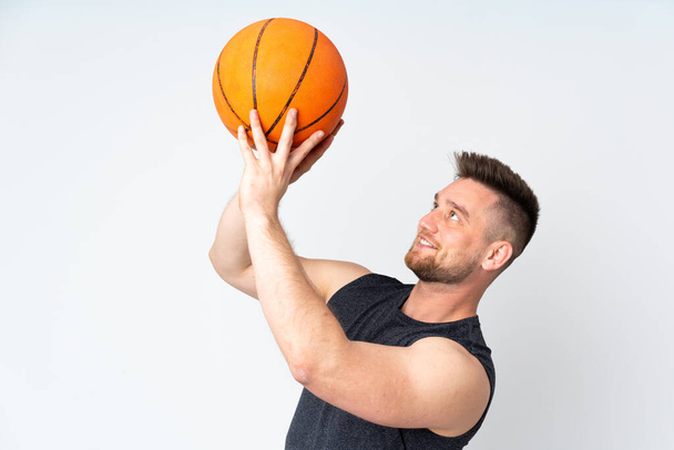 Russian handsome man isolated on white background playing basketball - Foto, immagini