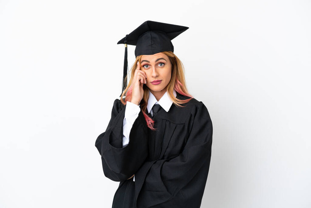 Young university graduate over isolated white background thinking an idea - Foto, immagini