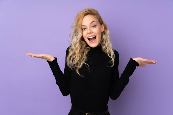 Young blonde woman isolated on purple background with shocked facial expression - Foto, Bild
