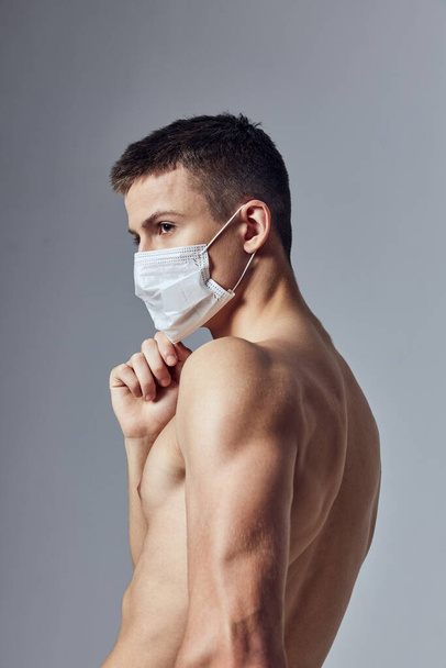 guy medical mask pumped up torso gym workout - Фото, изображение