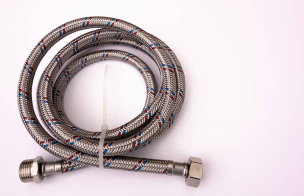Flexible metal water hose in stainless steel braid on white isolate - Photo, Image