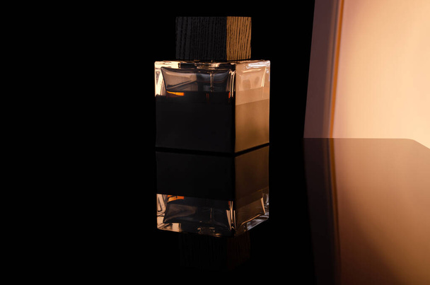 Perfume bottle on black background with reflection - Фото, зображення