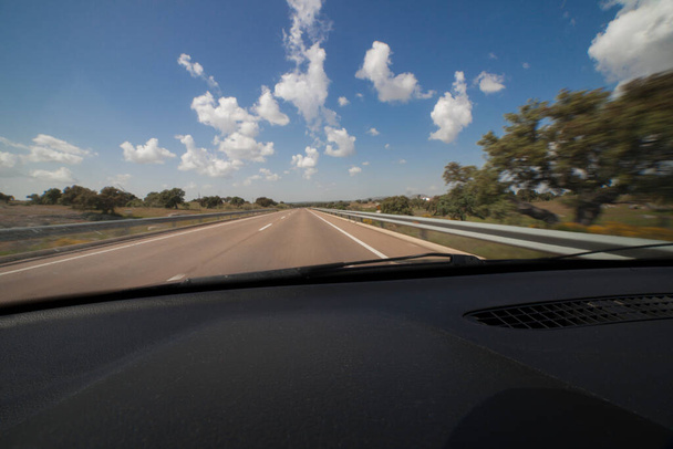 Driving a sunny nice day by local country road of Extremadura, Spain. Motion blurred inside view - Photo, Image
