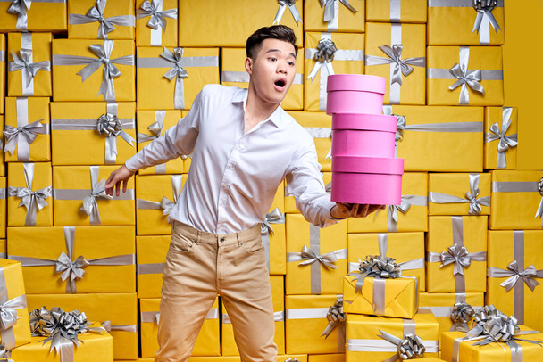 Time For Celebration. Hurrying emotional asian guy holding present box in hands, going to congratulate - Fotoğraf, Görsel